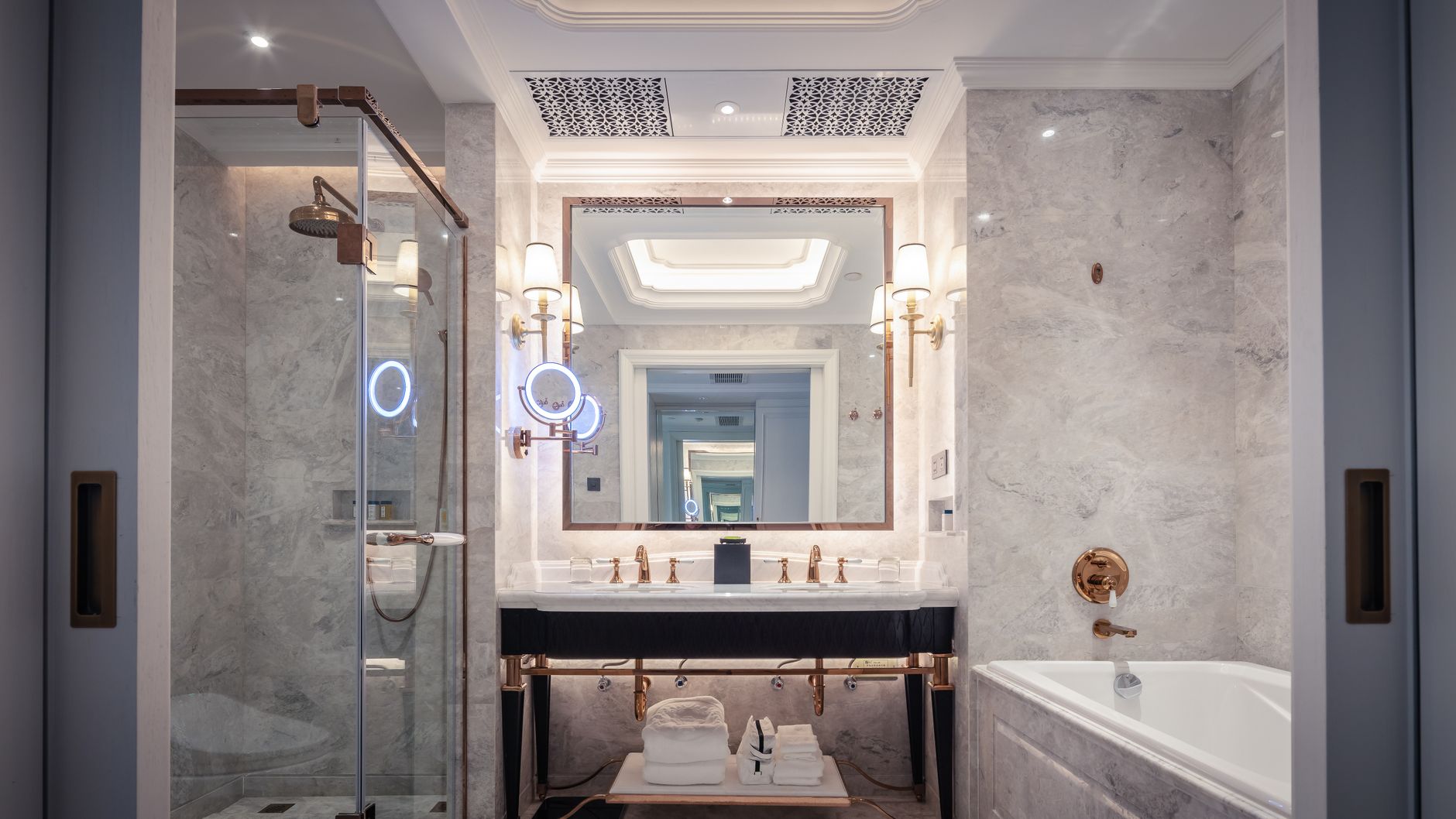 Elegant bathroom featuring a marble sink, bathtub, and mirror with ambient lighting in Lakewood, CA